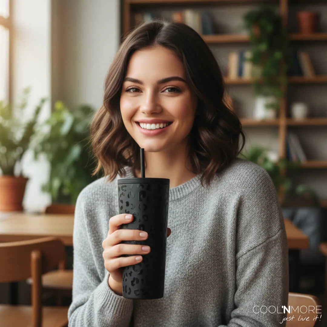 A person holding a black cup with a straw

AI-generated content may be incorrect.