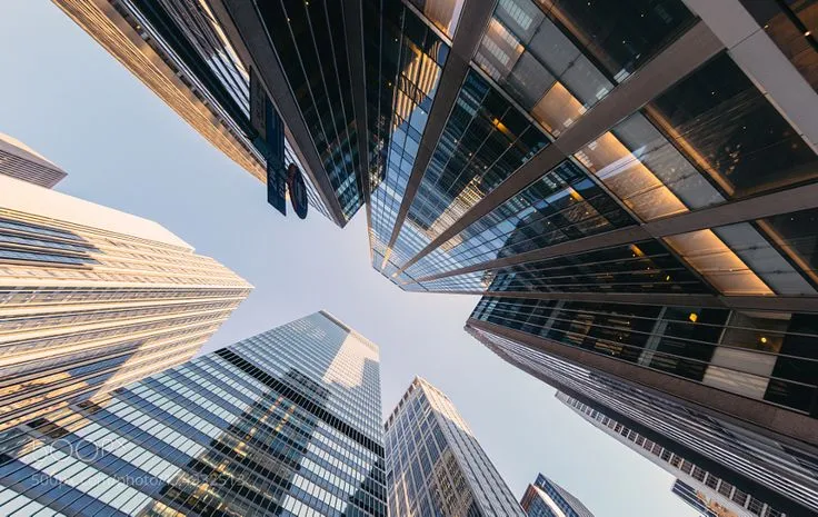This may contain: looking up at tall buildings in the city