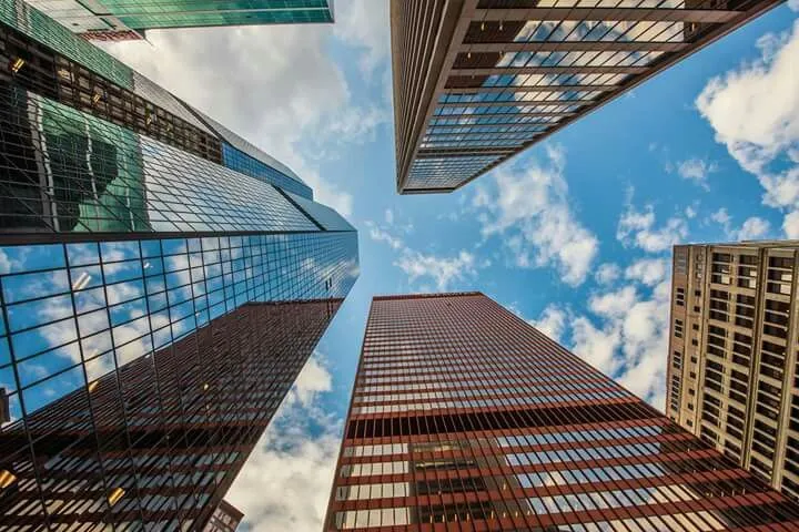 This may contain: looking up at tall buildings in the city