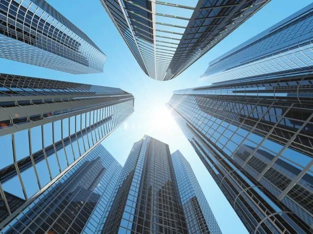 This may contain: looking up at skyscrapers from below in the city with sun shining down on them