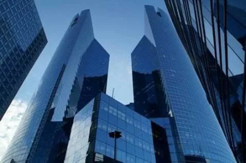 This may contain: some very tall buildings that are next to each other in the day time lapse