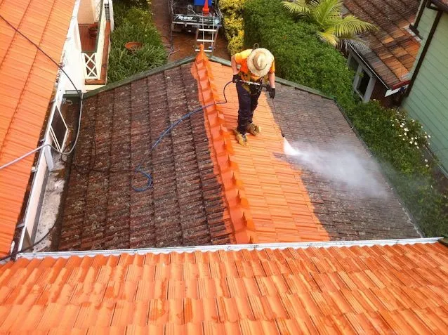 This may contain: a man is spraying water on the roof