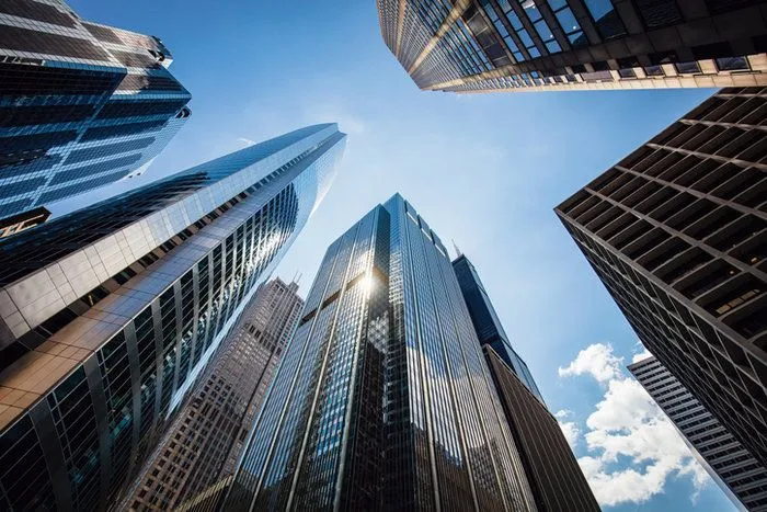 This may contain: looking up at skyscrapers from the ground