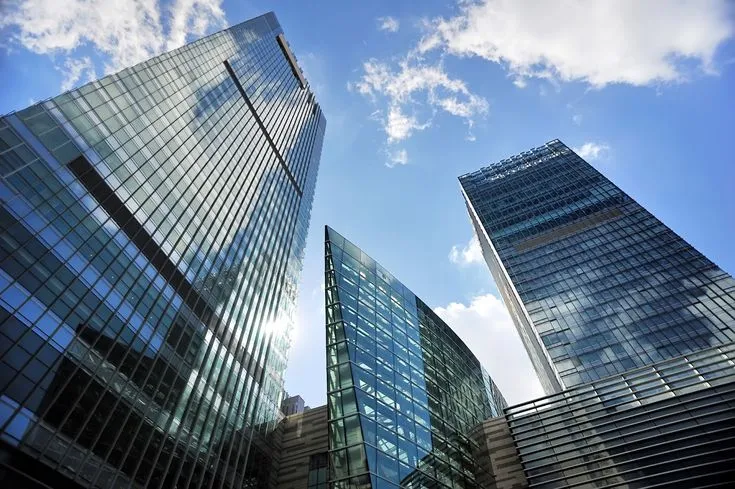 This may contain: several tall buildings with the words government backed commercial estate loan part 1 of 2 on them