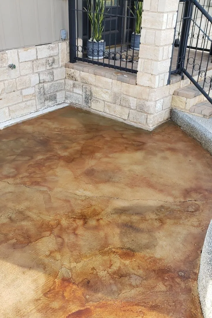 This may contain: a concrete patio that has been stained brown
