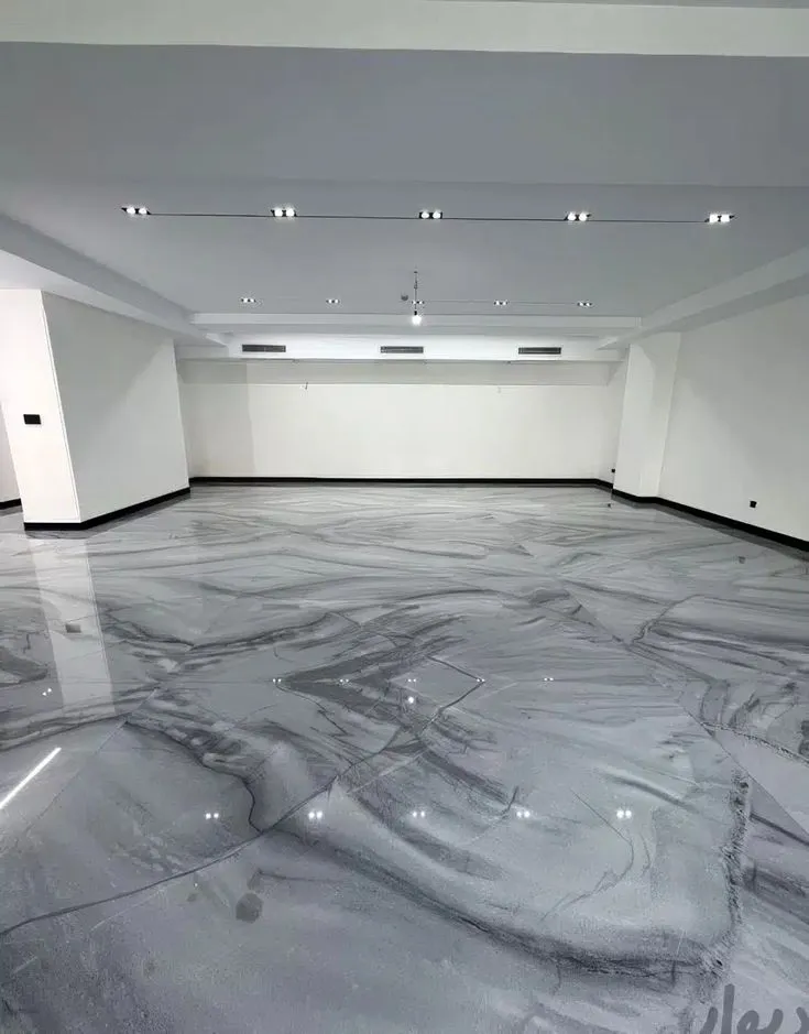 This may contain: an empty room with marble floors and white walls