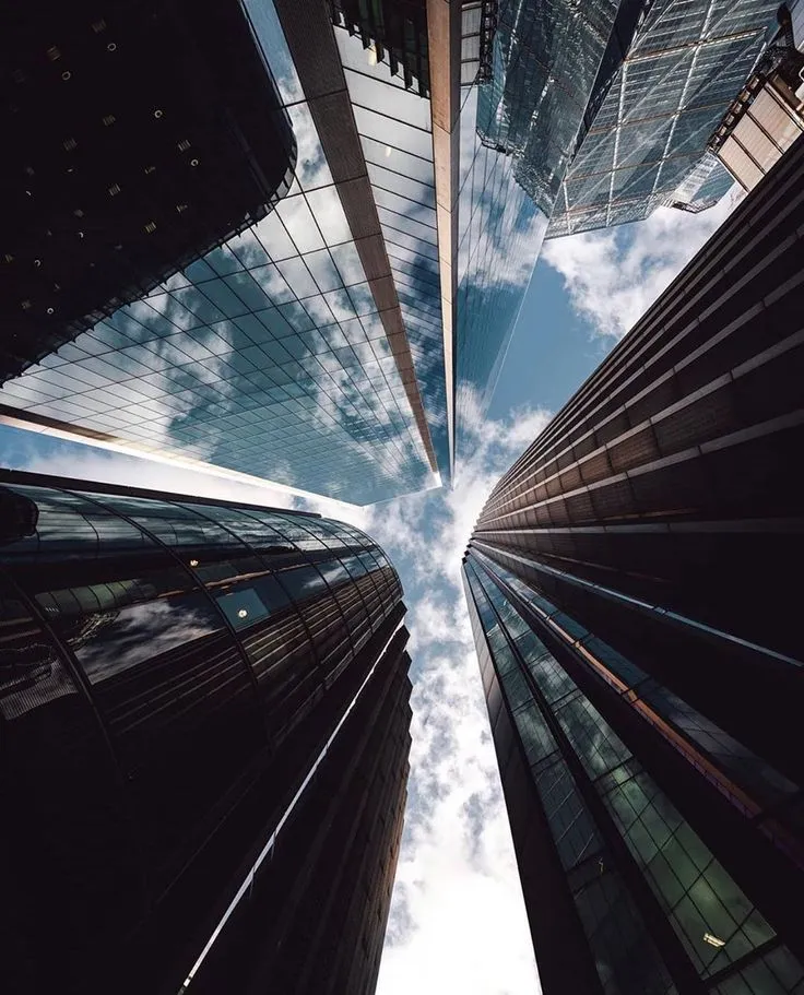 This may contain: looking up at tall buildings in the city