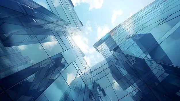 This may contain: some very tall buildings in the sky with clouds and blue skies behind them, as seen from ground level
