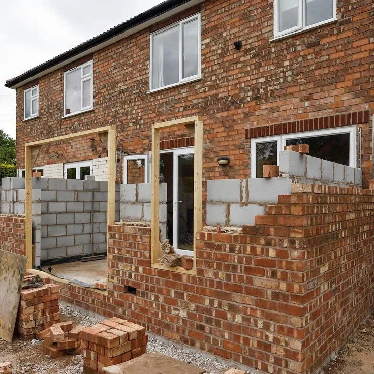 This may contain: a brick house being built in the process of construction