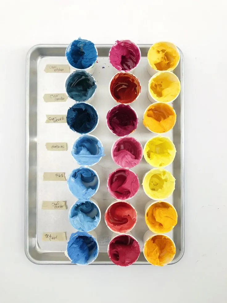 This may contain: the tray has many different colors of paint in it