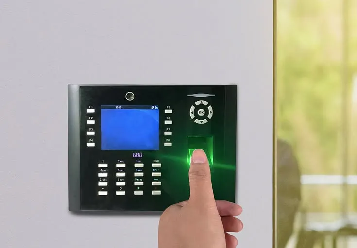 This may contain: a finger presses on the control panel for an appliance in a room with large windows