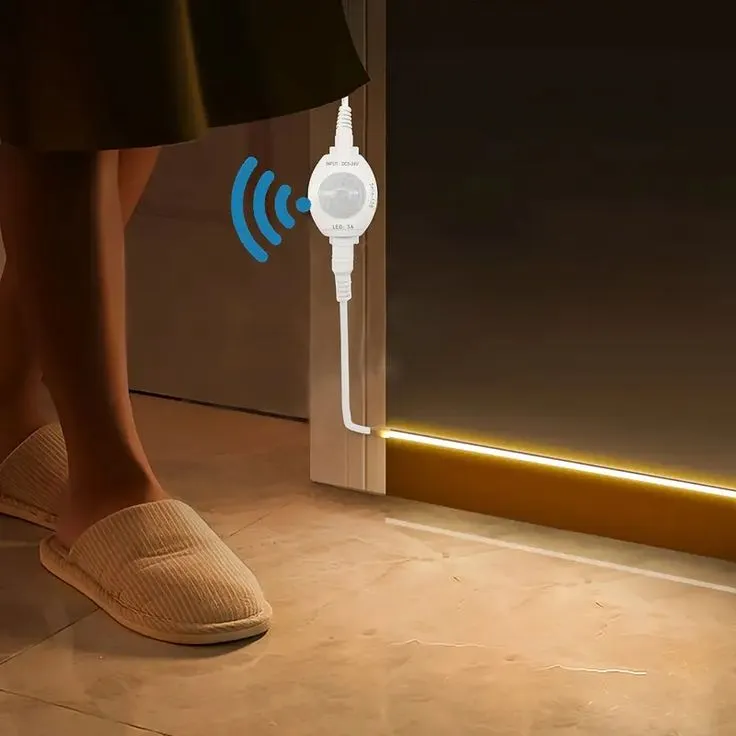 This may contain: a woman standing in front of a door with an electronic device connected to her foot