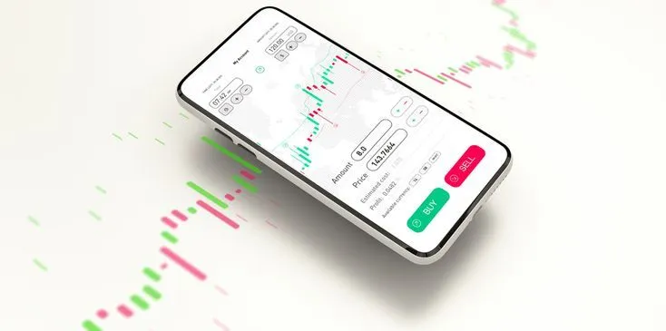 This may contain: a cell phone with an app on top of it next to a stock market chart