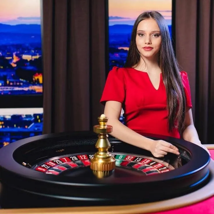 This may contain: a woman in a red dress standing next to a roule