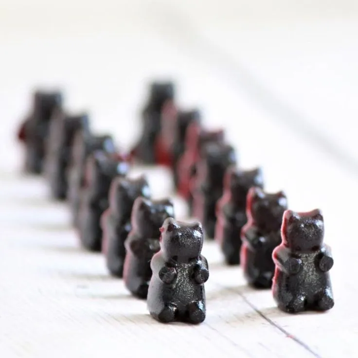 This may contain: small black bears are lined up on the table