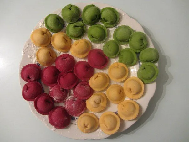 This may contain: there is a plate that has different colored desserts on it
