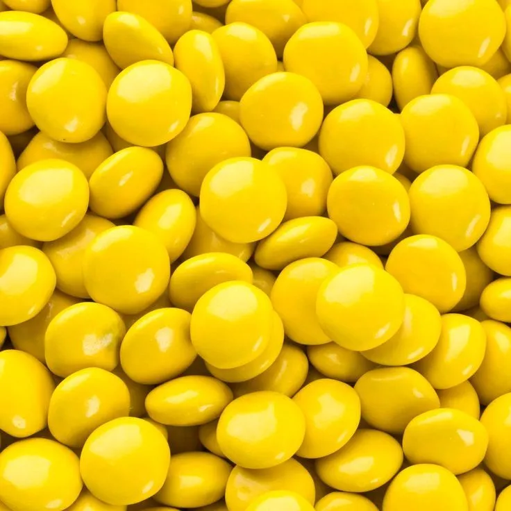 This may contain: close up view of yellow candy balls