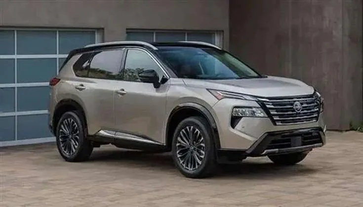 This may contain: a silver suv parked in front of a garage
