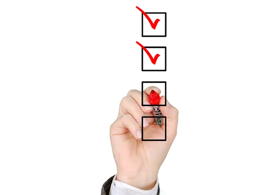 Hand ticking boxes on a checklist representing DORA testing obligations for financial firms