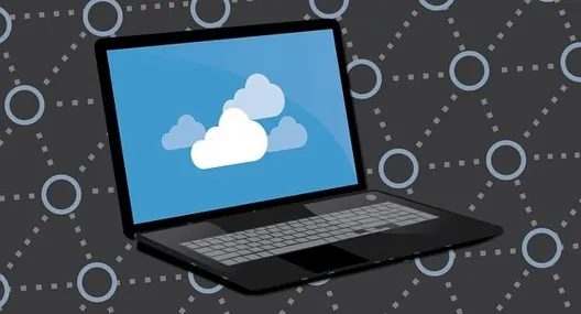 Laptop showing a cloud icon on a connected network during an AWS infrastructure as code review