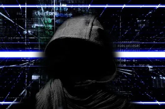 Hooded figure over binary code representing an attacker using a forgotten service account