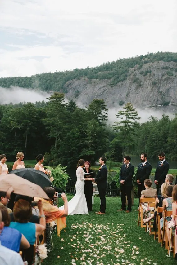 This may contain: a couple getting married at their outdoor ceremony