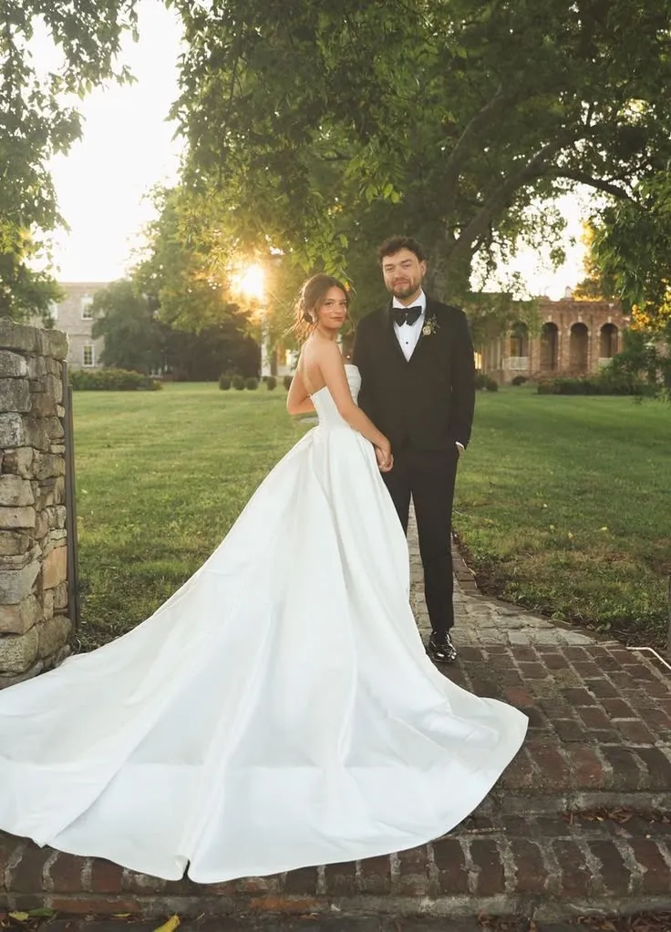This may contain: the bride and groom are posing for a photo