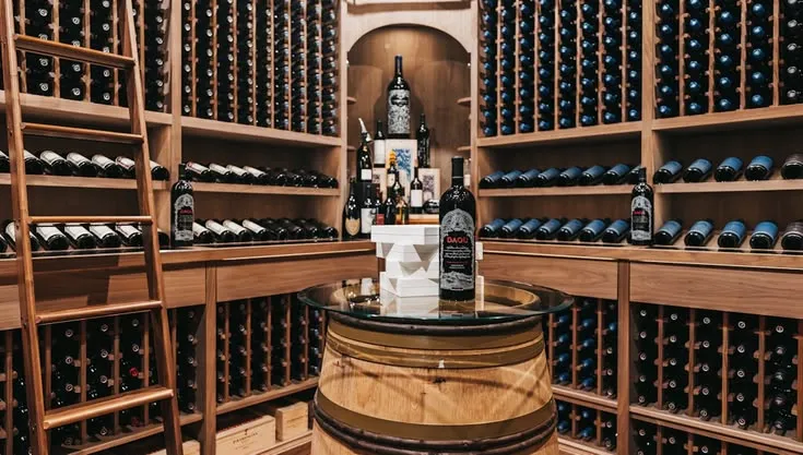 This may contain: a wine cellar filled with lots of bottles