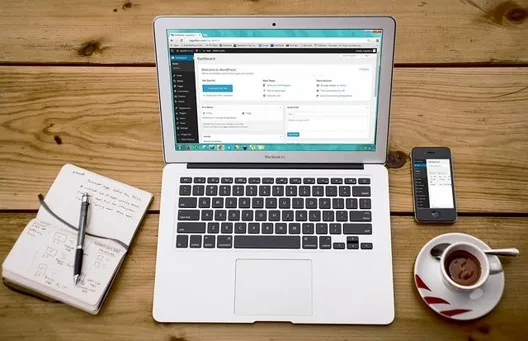 Laptop and notebook on a desk representing an architecture review of API routing