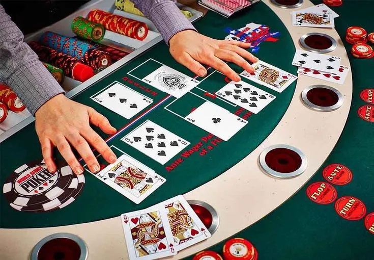 This may contain: a person playing cards at a casino table