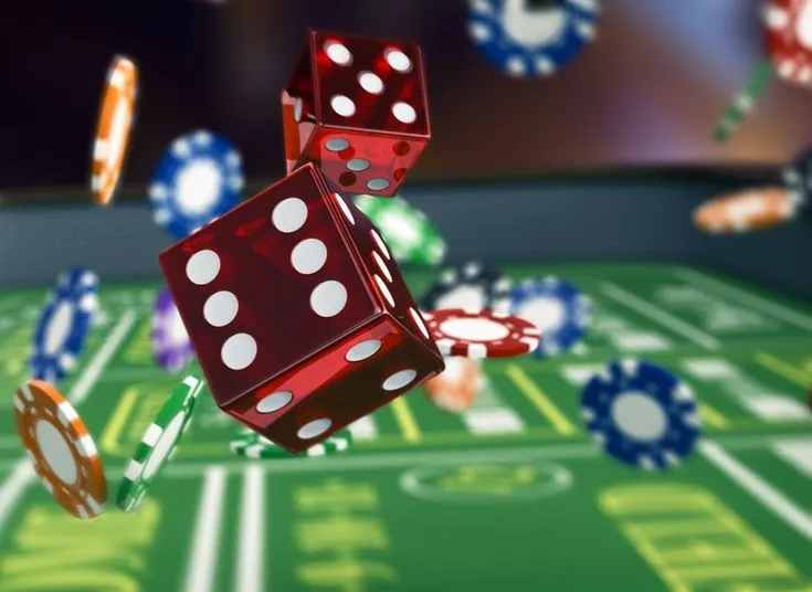 This may contain: two red dices are falling into the air on a green table with casino chips