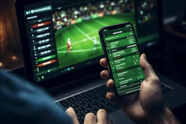 This may contain: a person holding a cell phone in front of a laptop with a tennis game on the screen