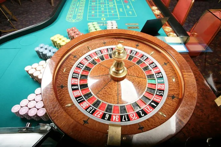This may contain: a casino rouleet sitting on top of a table next to other gambling chips