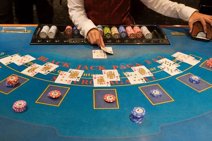 This may contain: a man playing blackjack at a casino table with lots of cards and chips on it