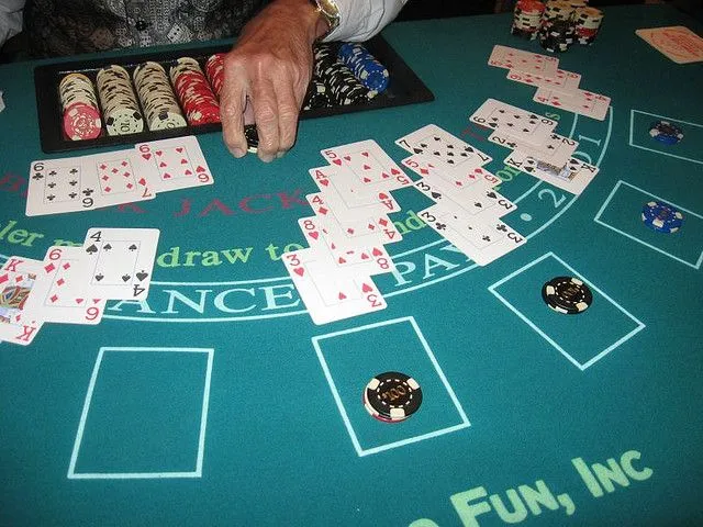 This may contain: a man sitting at a table with cards and chips