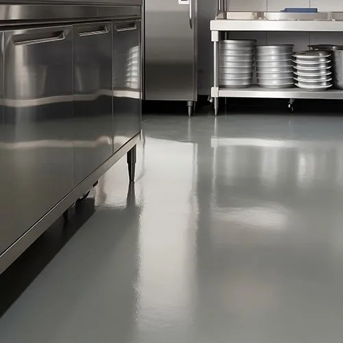 This may contain: an industrial kitchen with stainless steel appliances and dishes on the counter top, in front of two refrigerators