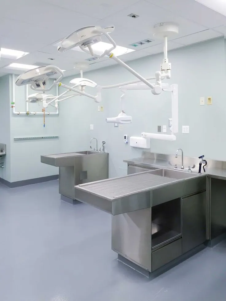 This may contain: an empty operating room with sinks and lights