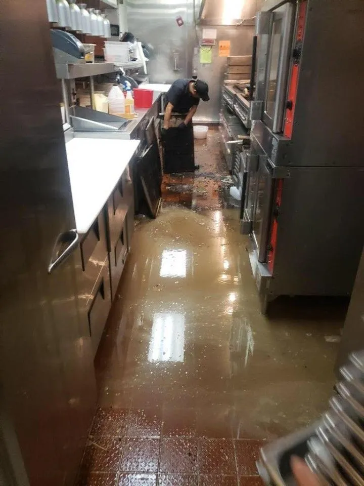 This may contain: a man standing in the middle of a kitchen
