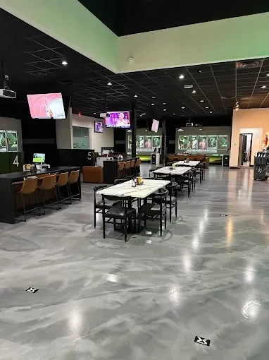 This may contain: an empty sports bar with tables and chairs