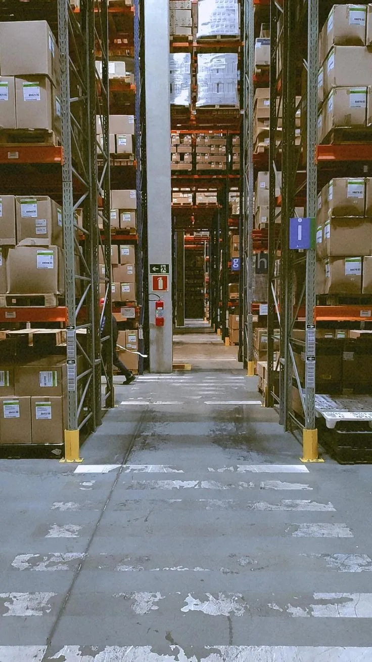 This may contain: an empty warehouse filled with lots of boxes