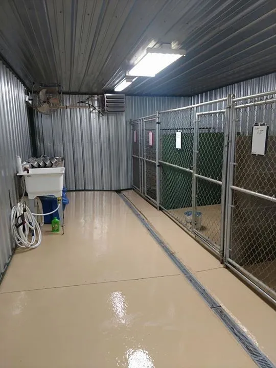 This may contain: the inside of a storage room with several items on the floor and in the fenced area