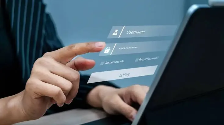 This may contain: a woman is typing on her laptop with the screen showing icons and symbols that appear to be protected