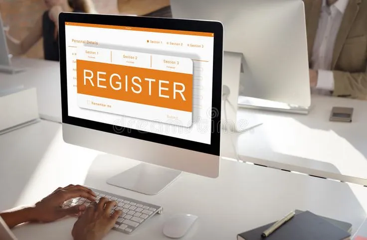 This may contain: a computer screen with the word register on it in front of people working at computers