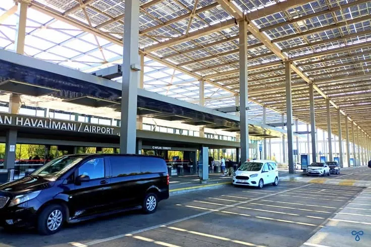 This may contain: an airport terminal with several cars parked in it