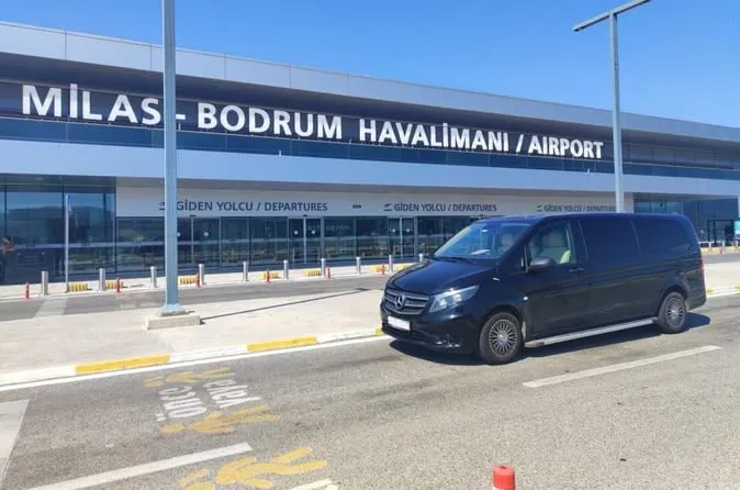 This may contain: a van is parked in front of an airport