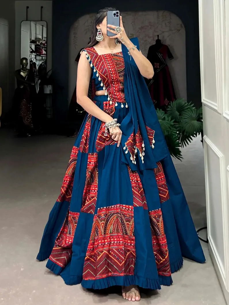 Woman wearing a blue and red ethnic lehenga choli with traditional embroidery