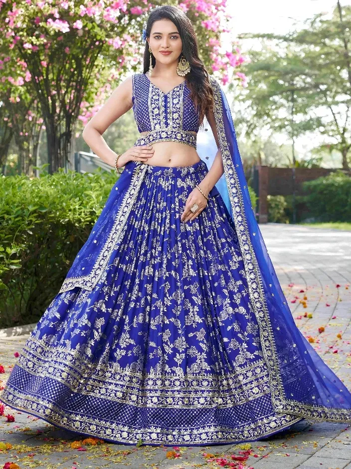 Royal blue embroidered lehenga choli with gold floral work, perfect for Indian weddings and festive occasions.