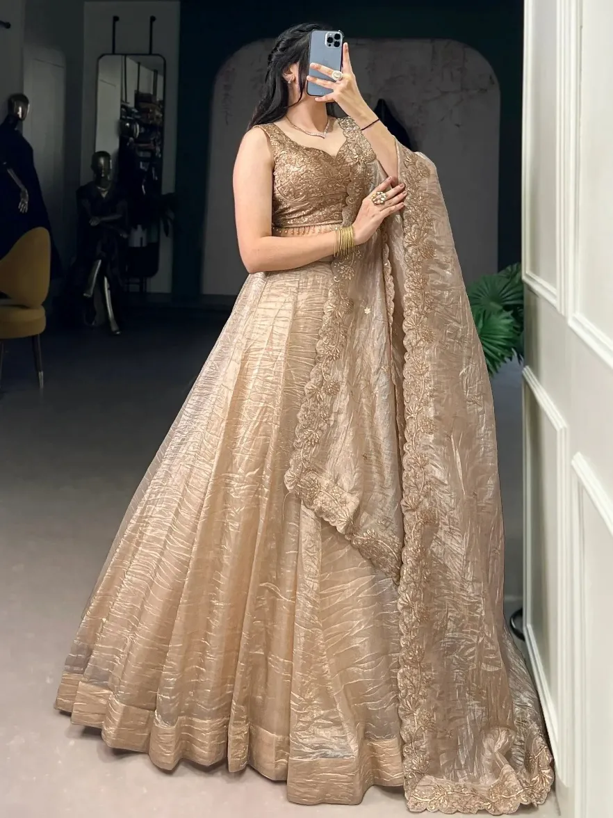 Elegant gold embroidered lehenga choli with floral detailing, perfect for Indian weddings and festive occasions.