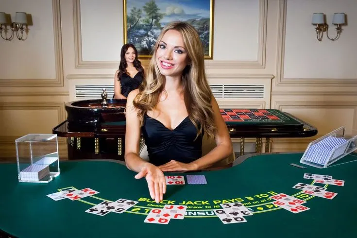 This may contain: a woman sitting at a blackjack table with two women in the background