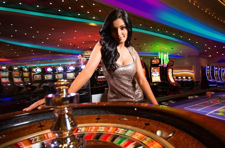 This may contain: a woman standing in front of a rouleette at a casino slot machine table